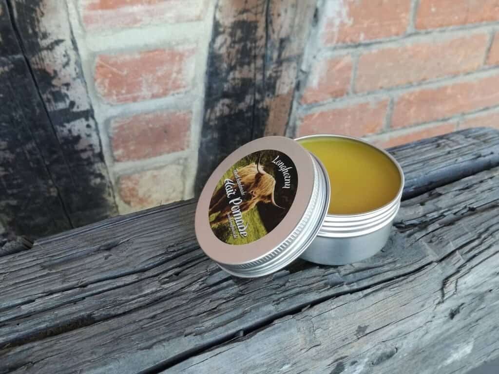 A tin of Pomade displayed outside on a post